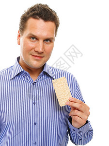 饮食健康的生活方式男人吃饼干工作室拍摄白色背景图片