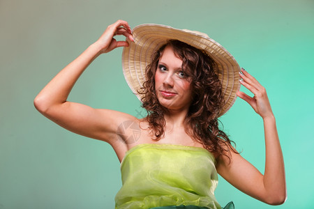 美丽的微笑春天或穿着帽子的夏天女人绿色概念背景图片