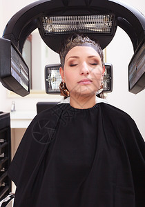 美发容院的女郎发型师理给死去的美女郎染现代专业设备图片