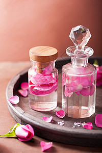 玫瑰瓶用玫瑰花和鲜火瓶装的炼粉和芳香疗法背景