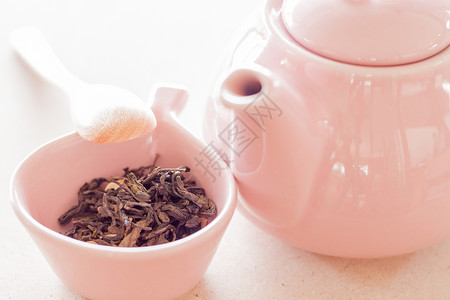 陶瓷杯中的乌龙茶罐子和木勺股票照片背景图片
