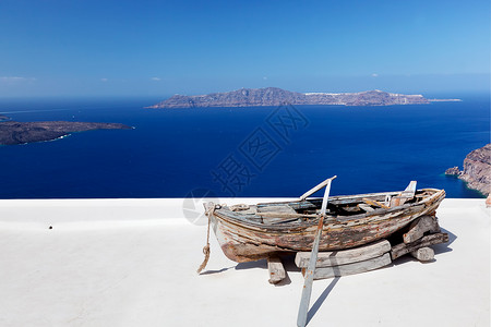 希腊圣托里尼岛大楼屋顶上的老船Caldera和爱琴海阳光明媚的一天蓝图片