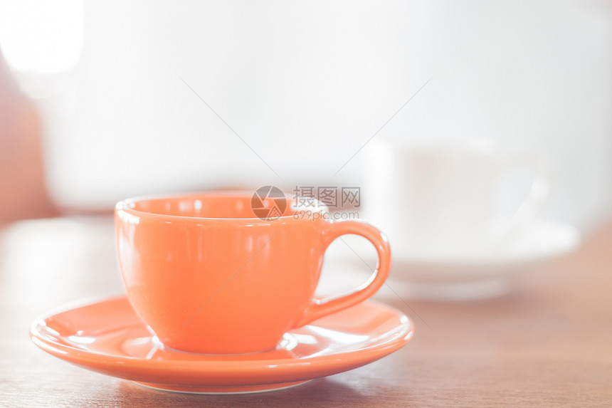 小型橙咖啡杯和白股票照片图片