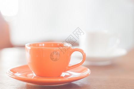小型橙咖啡杯和白股票照片背景图片