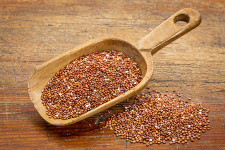红quinoa粮食红奎诺亚与格伦基木制餐桌对背景图片