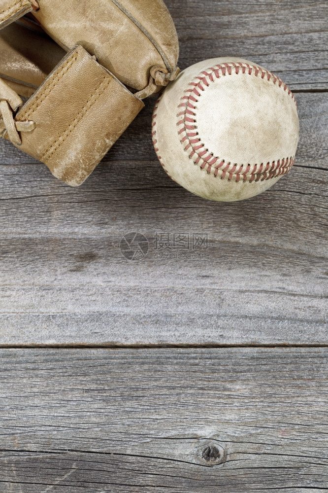旧棒球的垂直顶端角度和生锈木上风湿的皮革手套有很多复制空间图片