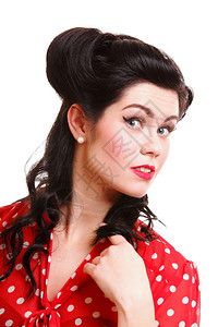 美的年轻女士配上针头化妆品和发型在演播室装扮图片