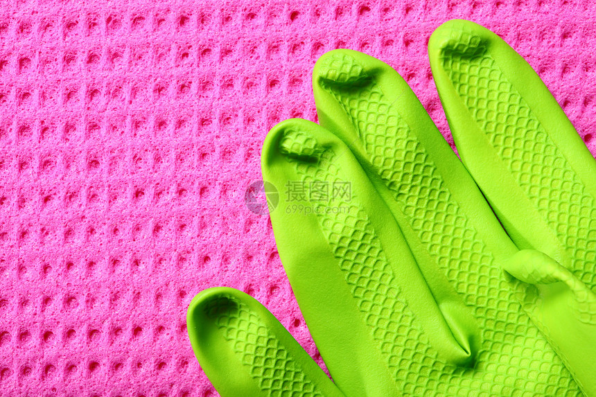 关闭粉色厨房海绵和绿橡胶手套图片