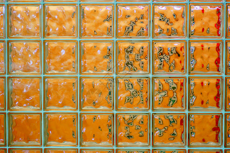 玻璃砖块壁的砖块背景或纹理的橙色红图片