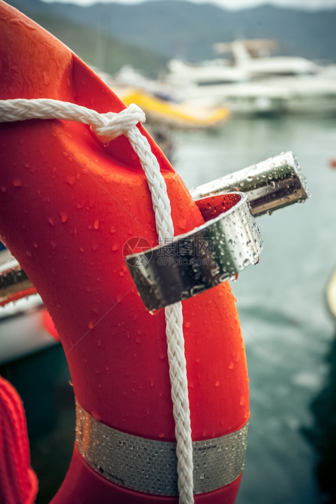 红色救生艇与绳索在海港对面的紧贴照片图片