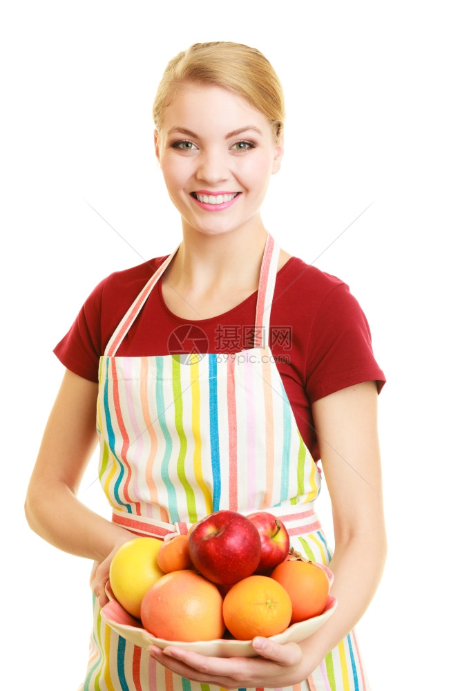 享受快乐的家庭主妇或厨师在带条纹的厨房围裙内提供健康水果与世隔绝图片