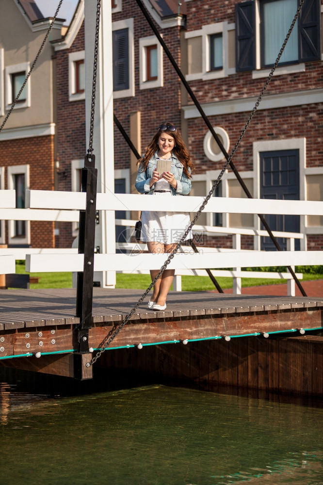 美丽的女人站在欧洲木桥上图片