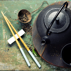 茶和铁制木餐桌上的筷子图片