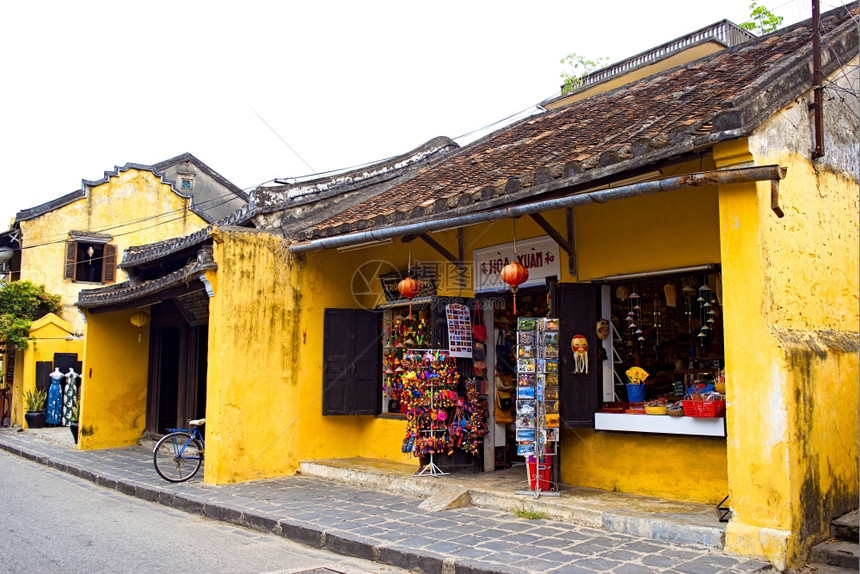越南广Hoi古城配有肩杆和牙帽的街摊商图片