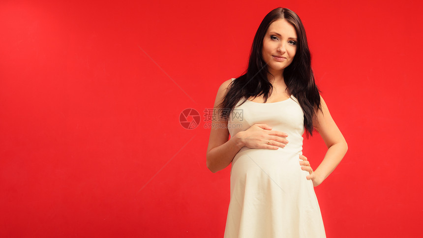 孕期母亲和幸福概念身着白衣穿与肚子相触的优雅孕妇图片