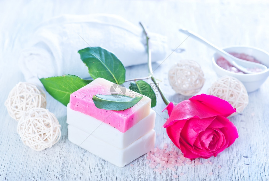 芳香肥皂和玫瑰花在桌子上图片