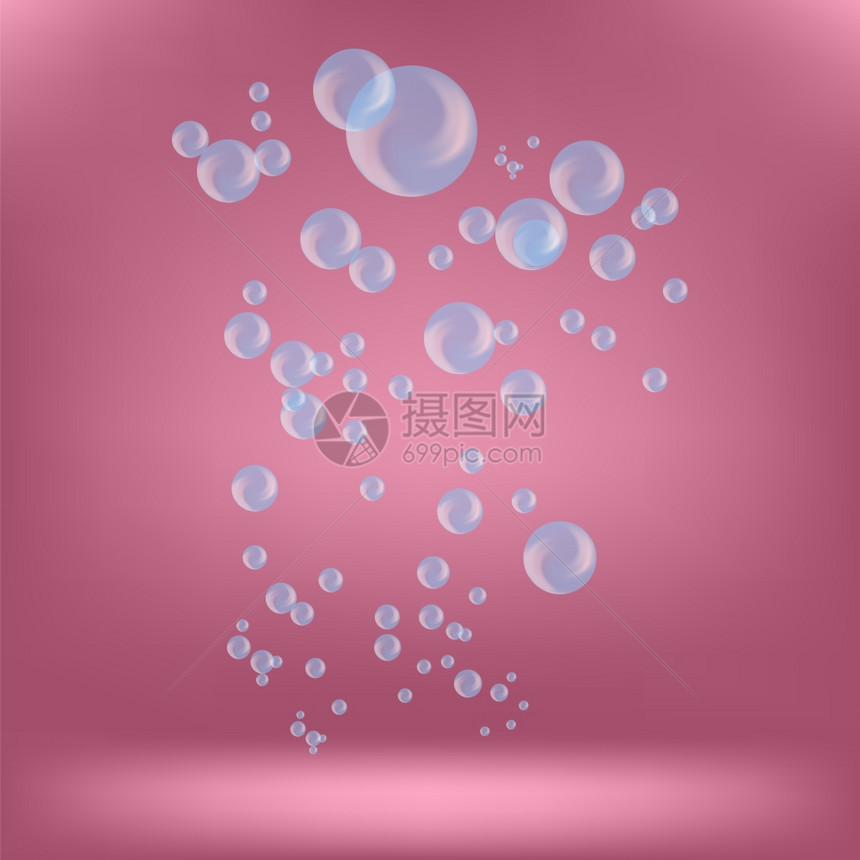 粉色背景上孤立的蓝肥皂泡图片