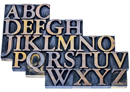 以蓝色和黄墨水染的旧式纸质印刷木型纸打块中的英文字母图片