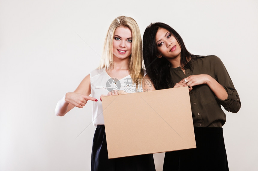 广告概念两位女艺人和非洲白板上空的横幅指着手工作室图片