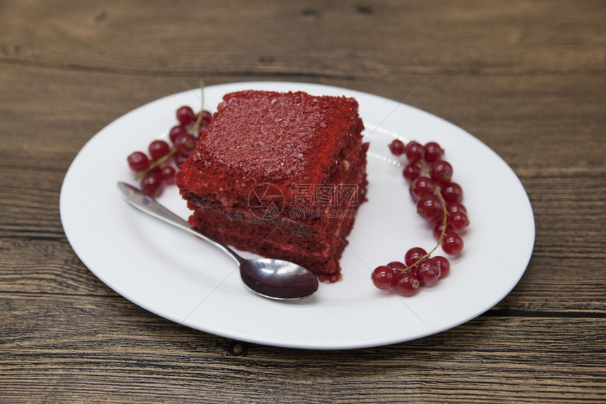 红天鹅绒新鲜的美味饮食蛋糕红圆饼在DukanDitt放在瓷板上勺子在木制背景上图片