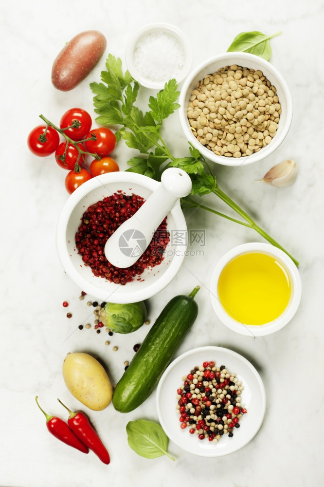 大理石桌上有各种多彩香料和蔬菜的迫击虫子烹饪健康或素食饮概念图片