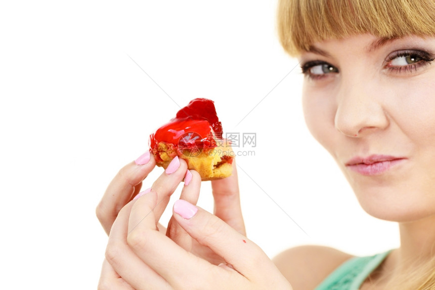 女人手握蛋糕吃着不健康的垃圾食品吃着甜点大口的甜点吃着不健康的垃圾食品图片