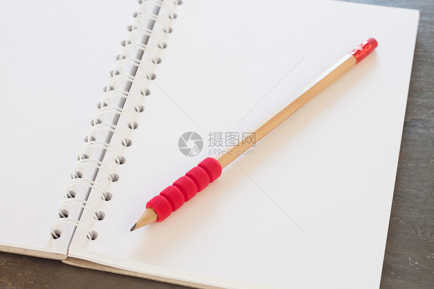 空白笔记本用灰色背景商业概念上的铅笔图片
