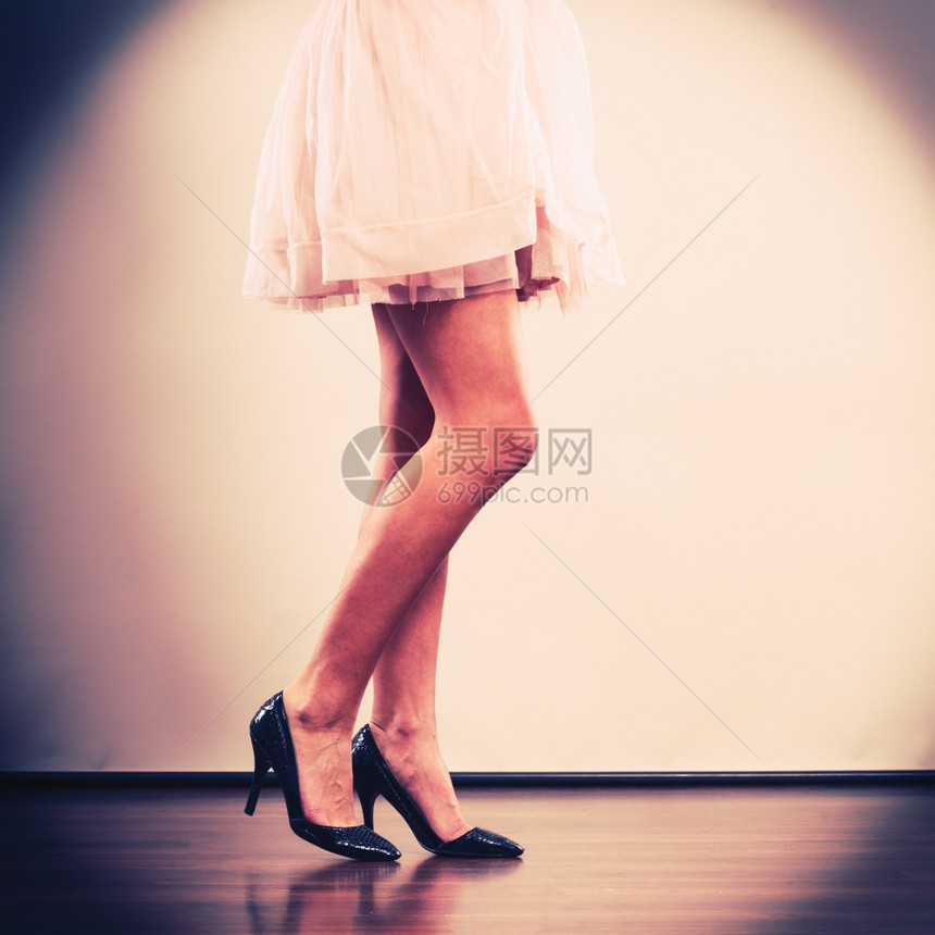 晚间庆祝时装概念穿着亮衣服的妇女在派对地板上穿着高跟鞋的女腿部图片