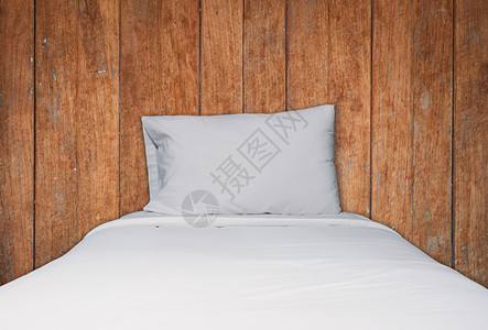 紧贴的白色床铺和枕头放在木质布料背景上股票照片图片