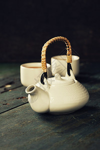 茶壶和木背景的杯子图片