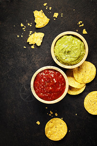 酱芯墨西哥玉米片芯配有自制新鲜的guacomole酱和旧背景的salsa和顶视图带有文本空间背景