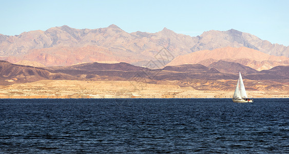 山岳占主要背景游艇沿米德湖移动图片