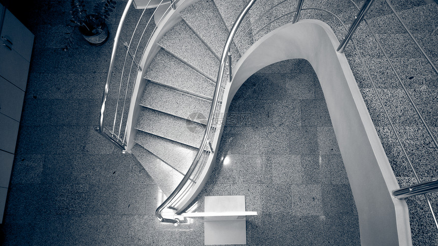 现代建筑中石块弯曲楼梯的单色图像图片