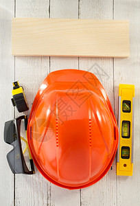 建筑头盔和木上的安全眼镜建筑头盔和木背景上的安全眼镜图片