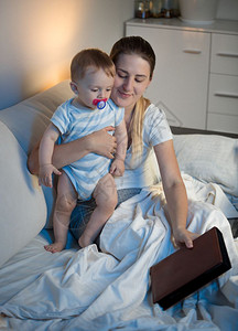 母亲和婴儿睡前阅读图片