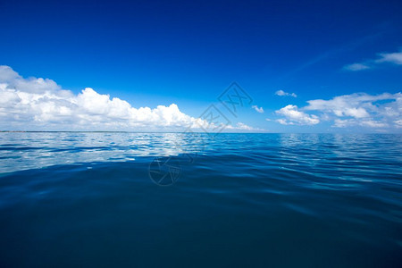 蓝云在平凉的海面上云在蓝的天空上阳光反射图片