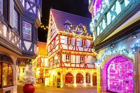 法国阿尔萨斯科勒马老城传统的Alsatian半平板房屋在法国阿尔萨斯的圣诞节时装饰和照亮背景