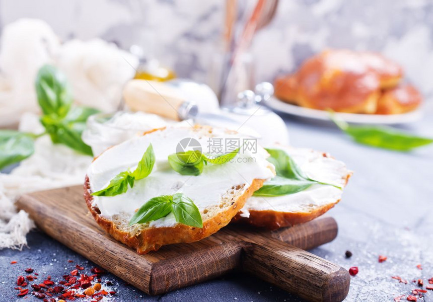 木板和桌子上含奶酪的面包图片