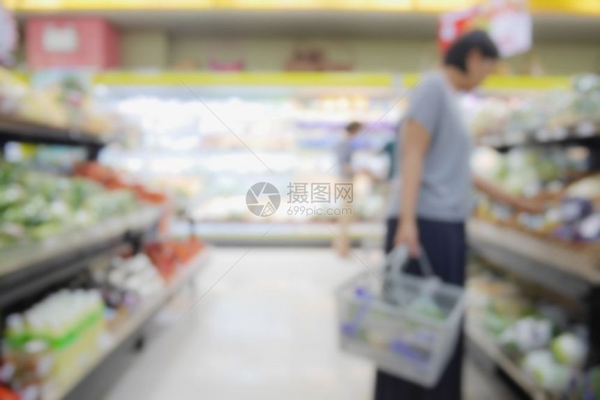 人们在超市购物的模糊抽象背景货架上有杂项产品图片