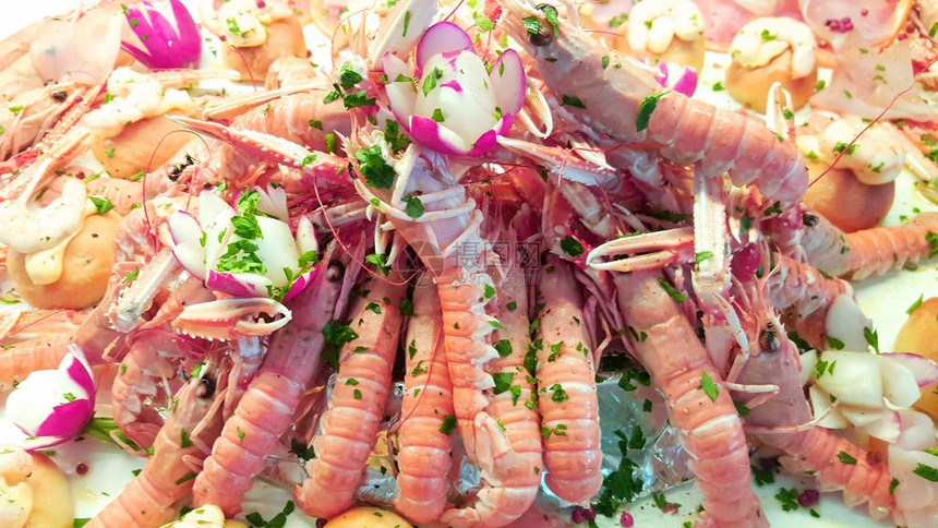 海鲜开胃菜加虾金鱼胡萝卜和葡萄水果切片图片