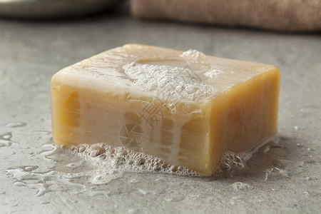 哈曼摩洛哥传统肥皂的湿瓦片含泡沫的香皂背景