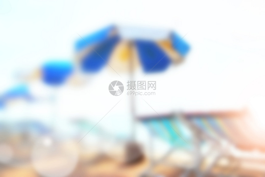 阳光沙滩带雨伞和椅子的沙滩没有焦点背景模糊图片
