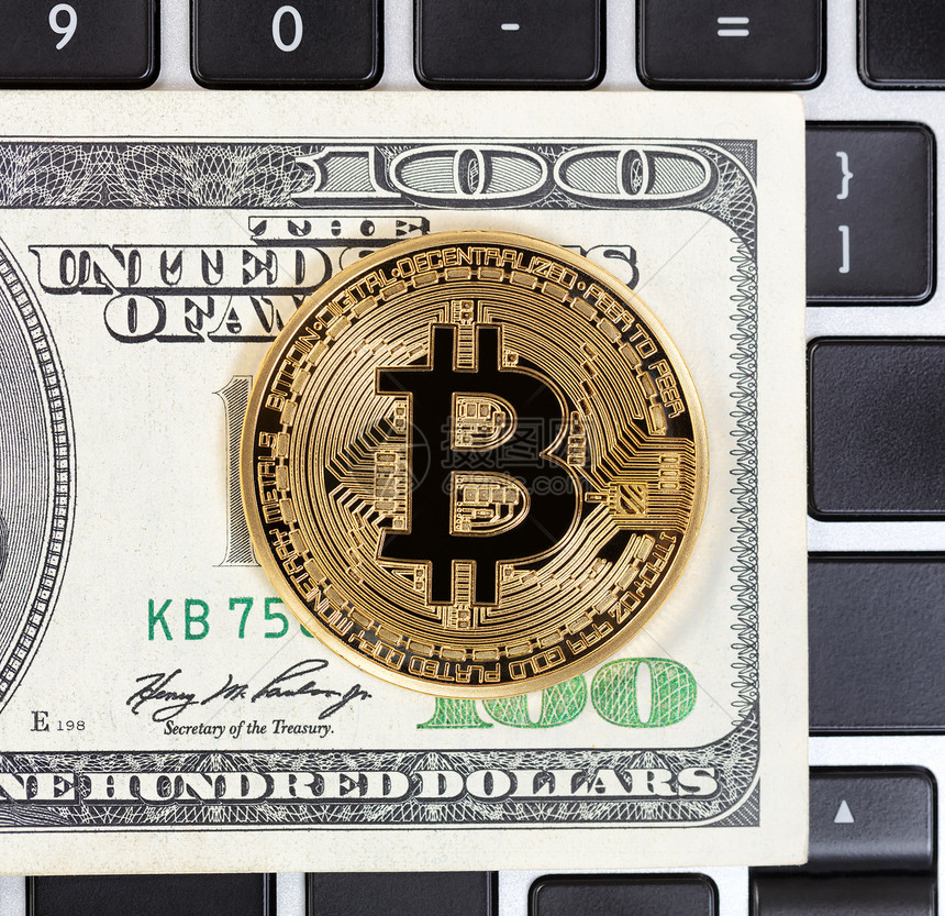 Bitcoin纸币背景键盘上的比特币网络单一硬图片