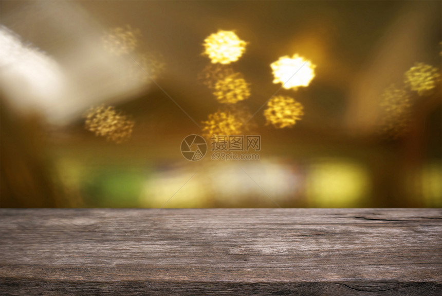 Bokeh光线的抽象模糊背景面前的空木质桌可用于显示或匹配您的产品装上以显示产品图片