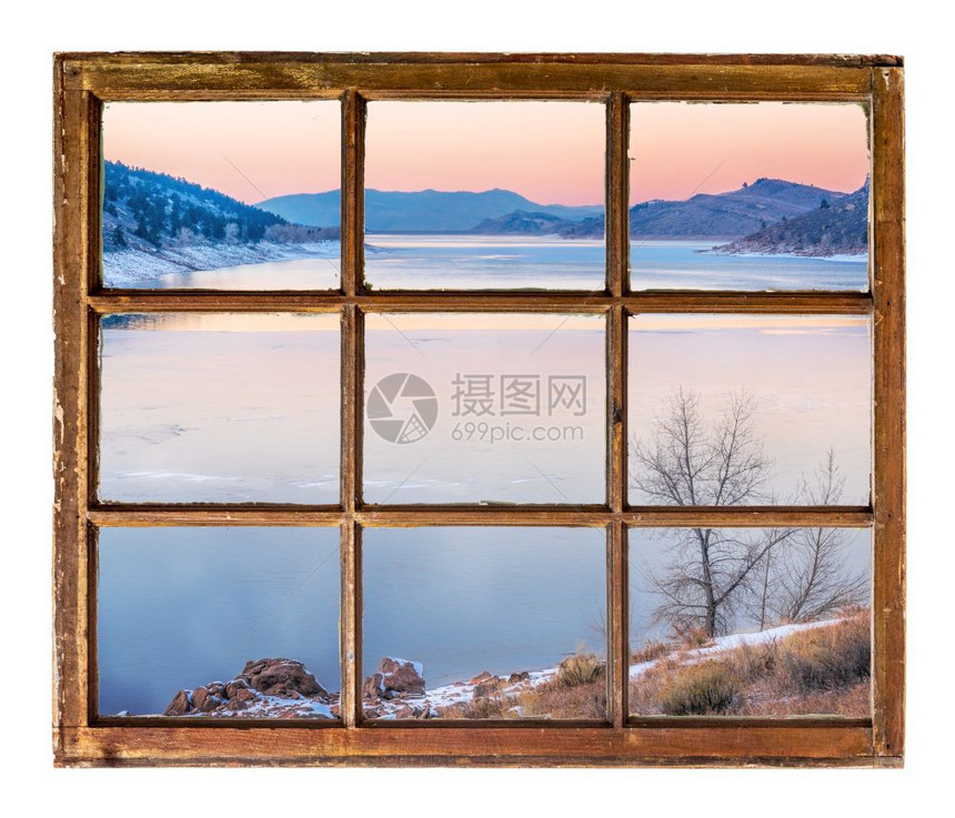 冬天在山湖的黄昏过冬从古老的冷用脏玻璃砸碎的窗户中看到图片