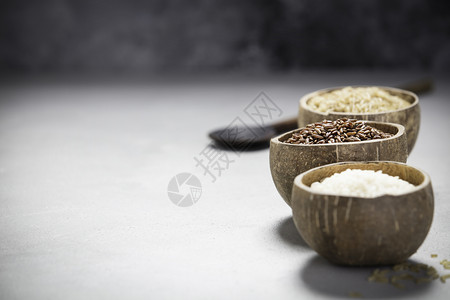 碗中不同大米的组合白混凝土底的米棕和Risotto大米图片
