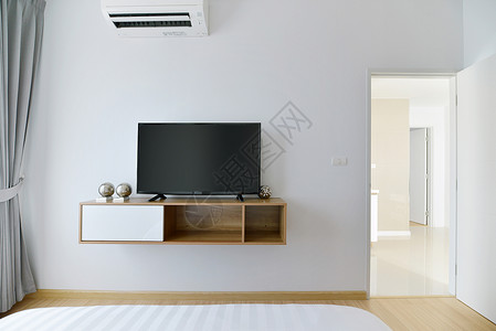 现代空卧室白色墙壁和木架上有带铅的电视机图片