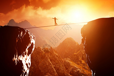 日落时人们在山顶悬崖上行走和平衡商业概念承担风险挑战集中图片
