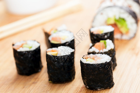 日本亚洲健康食品寿司卷包括鲑鱼鳄梨海藻和筷子寿司卷包括鲑鱼海藻和筷子图片