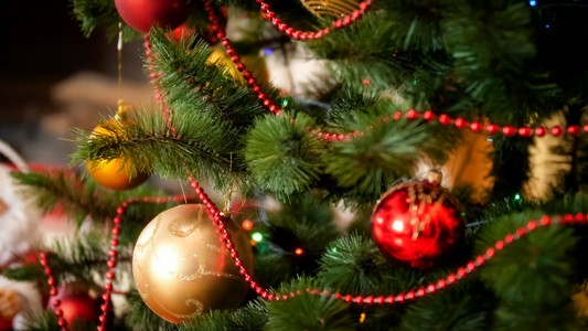 在美丽的圣诞树上挂着金和红胶片图片